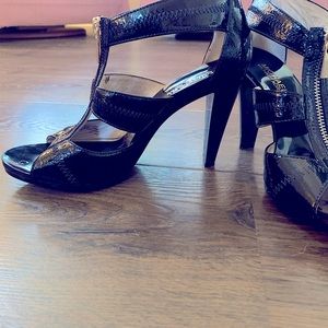 Black patent leather 4” heels with nonslip sole.